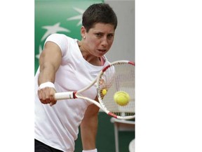 Spain’s Carla Suarez Navarro returns the ball to Canada’s Eugenie Bouchard during their French tennis Open quarter final match at the Roland Garros stadium in Paris on June 3, 2014.