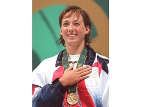 US Olympic team Amy Van Dyken sings the national anthem at awards ceremony for women's 50m freestyle July 26, 1996 at the Georgia Tech Aquatic Center in Atlanta. Van Dyken has sustained injuries in an all-terrain vehicle accident in Arizona.