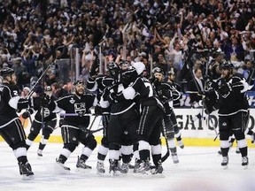 Members of the Los Angeles Kings celebrate Justin Williams's goal in overtime of Game 1 in the NHL Stanley Cup Final hockey series against the New York Rangers on Wednesday, June 4, 2014, in Los Angeles.