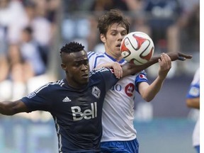 Vancouver Whitecaps' Gershon Koffie, left, and Montreal Impact's Maxim Tissot vie for the ball during first half MLS soccer action in Vancouver, B.C., on Wednesday June 25, 2014.