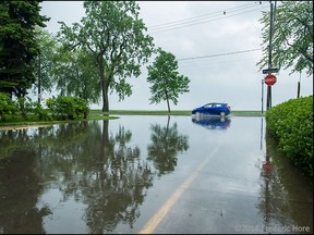 Flash flooding from a severe storm turned streets into rivers and lakes in this view at boul St Joseph and 49th St in Lachine Quebec, Tuesday, June 3, 2014. Photo ©2014 Frederic Hore, RemarkableImages.ca