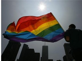 A file photo shows the rainbow flag being raised at City Hall in Toronto. WorldPride 2014 starts in that city on June 20.