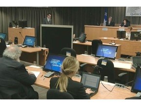 An unidentified retired engineer testifies behind a screen to protect his identity at the Charbonneau Commission on Thursday, June 12, 2014 in Montreal. Thewitness resumed his testimony on Friday.