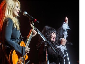 Ann Wilson, of the band Heart, belts out a song next to her sister, Nancy, left, during their concert at the Bell Centre in Montreal, on Saturday, June 14, 2014.