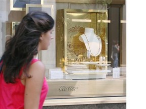 A woman walks past the Cartier store on Toronto’s upscale Bloor Street. The ranks of Canada’s millionaires swelled last year.