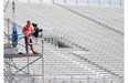 A worker mans a camera positioned at the first turn near the end of the track entry from pit lane at Circuit Gilles Villeneuve on Wednesday.