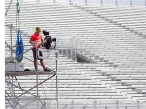 A worker mans a camera positioned at the first turn near the end of the track entry from pit lane at Circuit Gilles Villeneuve on Wednesday.