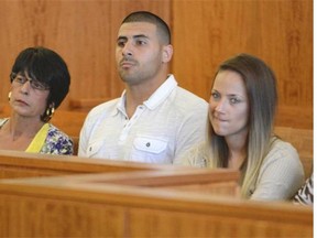 Aaron Hernandez’ mother Terri Hernandez, left, brother D.J. Hernandez, center, and an unidentified woman listen to proceedings during a hearing in Fall River superior court Monday July 7, 2014, in Fall River. Mass.  The  Judge agreed that Hernandez could be moved to a jail closer to Boston while he awaits his trial for the murder of Odin Lloyd.