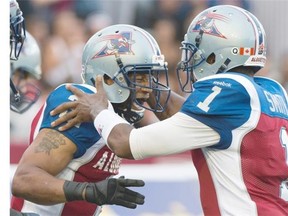 Alouettes’ Brandon Whitaker celebrates his first-quarter touchdown with quarterback Troy Smith during the team’s home opener at Molson Stadium Friday night.