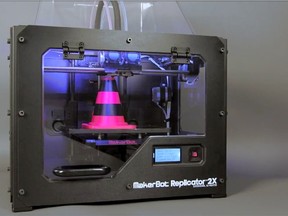 MakerBot Replicator 3d printer making a traffic cone.