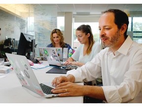 Philippe Telio finalizes arrangements Thursday for the fourth edition of the International Startup Festival with Pamela Perrotti, left, Rebecca Croll and Katherine Johnsen.