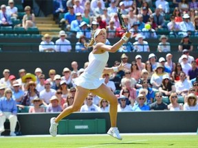 Canada’s Eugenie Bouchard returns to Germany’s Angelique Kerber during their women’s singles quarter-final match on day nine of the 2014 Wimbledon Championships at The All England Tennis Club in Wimbledon, southwest London, on July 2, 2014. Bouchard won 6-3, 6-4.