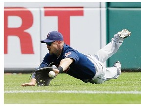 Cleveland Indians’ Ryan Raburn dives but misses the double by Detroit Tigers’ Victor Martinez during the sixth inning of a baseball game, Sunday, July 20, 2014 in Detroit.