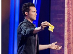 Comic and magician Justin Willman folds a banana as part of his act at a gala hosted by Jim Gaffigan at Salle Wilfred Pelletier as part of the Just For Laughs festival in Montreal, Sunday, July 27, 2014.