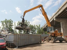 A car is dropped into a container at Century Steel Inc. in Lachine.