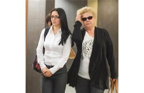 Emma Czornobaj left, leaves the Montreal Court room with a supporter. Czornobaj has been found guilty of criminal negligence causing two deaths when she stopped her car on a highway to avoid hitting a family of ducks.