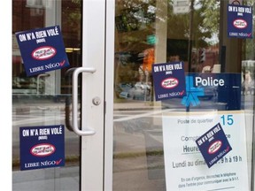 The entry to police station 15 on de L’ Eglise street has been tagged with union stickers protesting proposed changes to the pension funds in Montreal on Wednesday July 16, 2014.