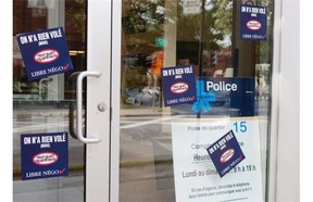 The entry to police station 15 on de L’ Eglise street has been tagged with union stickers protesting proposed changes to the pension funds in Montreal on Wednesday July 16, 2014.