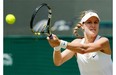 Eugenie Bouchard of Canada plays a return to Angelique Kerber of Germany during their women’s singles quarter-final match at the All England Lawn Tennis Championships in Wimbledon, London, Wednesday, July 2, 2014.