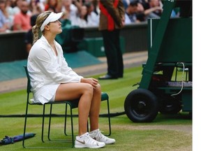 Eugenie Bouchard of Westmount sits in a chair after being defeated by Petra Kvitova of the Czech Republic during the women’s singles final at the All England Lawn Tennis Championships in Wimbledon, London, Saturday, July 5, 2014.