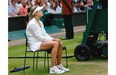 Eugenie Bouchard of Westmount sits in a chair after being defeated by Petra Kvitova of the Czech Republic during the women’s singles final at the All England Lawn Tennis Championships in Wimbledon, London, Saturday, July 5, 2014.