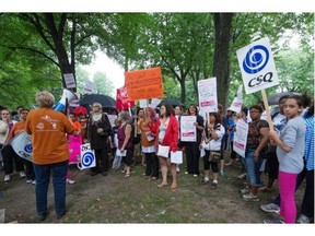Home daycare workers gather for a lunchtime protest at Parc LaFontaine in Montreal, on Monday, July 7, 2014. Daycare workers are pressuring the government to pick up the pace of contract negotiations, mainly over salary issues.