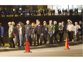 Hundreds of mourners participate in a candlelight march following a midnight mass in Lac-Mégantic, Sunday, July 6, 2014.