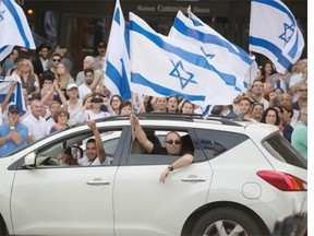 Hundreds of supporters of Israel gather in front of the Federation CJA and the Centre for Israel and Jewish Affairs Quebec building in Montreal Monday.