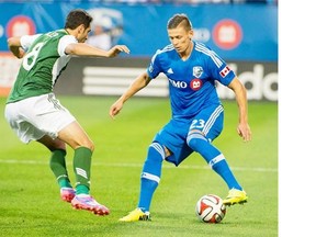 Impact’s Krzysztof Krol controls the ball in front of Timbers’ Diego Valeri during first-half action Sunday night in Montreal.