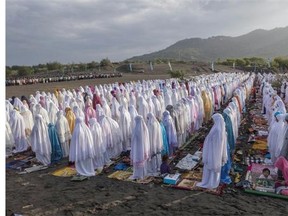 Indonesian Muslims perform Eid al-Fitr prayer on ‘sea of sands’ at Parangkusumo beach on July 28, 2014 in Yogyakarta, Indonesia. Eid al-Fitr, marks the end of Ramadan, the Islamic month of fasting and begins after the sighting of a new crescent moon. On this day, Muslims in countries around the world start the day with prayer and spend time with family, offer gifts and often give to charity.