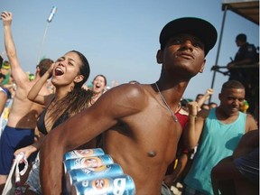 An informal beach vendor carries beer for sale on Copacabana Beach on June 28, 2014 in Rio de Janeiro, Brazil. The beach has seen a proliferation of informal vendors from both Brazil and abroad as tourists have gathered for the World Cup.