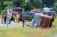 Investigators look over the scene of a bus accident that killed Chelssy Mercier, 14, on Interstate 87 in North Hudson, N.Y., on Friday July 18, 2014. John DiGiacomo/The Associated Press