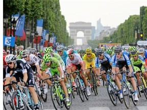 Italy’s Vincenzo Nibali, centre, wearing the overall leader’s yellow jersey, rides in the pack during the 137.5-kilometre 21st and last stage of the 101st edition of the Tour de France cycling race on Sunday between Évry and Paris.