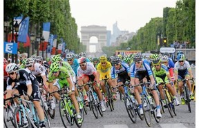 Italy’s Vincenzo Nibali, centre, wearing the overall leader’s yellow jersey, rides in the pack during the 137.5-kilometre 21st and last stage of the 101st edition of the Tour de France cycling race on Sunday between Évry and Paris.