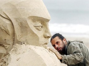 Jonathan Bouchard works on his sand sculpture at Revere Beach in Revere, Mass., Wednesday, July 16, 2014, for the upcoming 2014 Revere Beach National Sand Sculpting Festival.