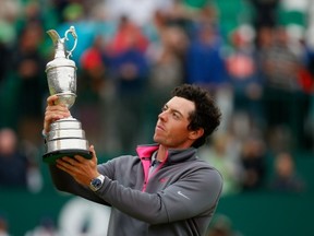 HOYLAKE, ENGLAND - JULY 20:  Rory McIlroy of Northern Ireland holds the Claret Jug aloft after his two-stroke victory at The 143rd Open Championship at Royal Liverpool on July 20, 2014 in Hoylake, England.  (Photo by Tom Pennington/Getty Images)