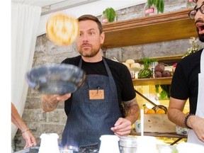 Chuck Hughes flips pancakes Wednesday morning at the Diesel store on de la Montagne St. as Na’eem Adam looks on.