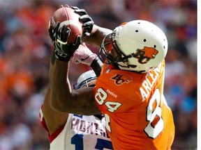 B.C. Lions’ Emmanuel Arceneaux, right, makes a touchdown reception as Alouettes’ Billy Parker defends during the first half in Vancouver on Saturday July 19, 2014.