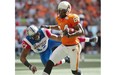 B.C. Lions’ Emmanuel Arceneaux, right, scores a touchdown as Montreal Alouettes’ Billy Parker defends during the first half of a CFL football game in Vancouver on Saturday July 19, 2014.