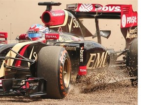 Lotus’ French driver Romain Grosjean ploughs through the gravel during the second practice session at the Silverstone circuit in Silverstone on July 4, 2014 ahead of the British Formula One Grand Prix.