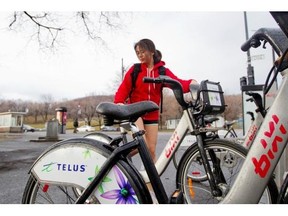McGill student Angie Ning rents a Bixi bike from the station at the corner of Mont Royal and Parc Aves. Tuesday, April 15, the start of the 2014 Bixi season.