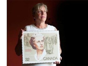 Michele Nadeau, president of the Therese Casgrain Foundation, holds a replica of a stamp depicting her grandmother Therese Casgrain.