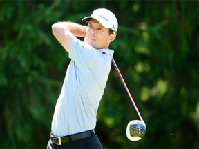 Mike Weir tees off on the eighth hole during first-round of play at the Canadian Open golf championship.