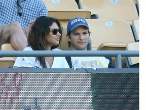 Mila Kunis with Ashton Kutcher at a ball game last month. Meeting him changed her mind about marriage, Kunis says.