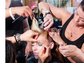 Model Anja Rubik, is made up backstage before the presentation of the Atelier Versace Fall Winter 2014-15 Haute Couture fashion collection, presented Sunday, July 6, 2014 in Paris.