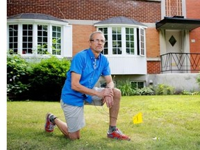 Montreal homeowner Eric Cook kneels on the property line of his N.D.G. area home in Montreal on Tuesday July 29, 2014. Cook is facing a $35,000 sewer repair bill and was shocked to learn the homeowner is responsible for their sewer all the way to the city connection, not the property line as most people believe to be the case.