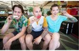 Myles Harrison, left, Julio Guajardo and Kate Chomyshyn are seen munching on their products at Satay Brothers in the Atwater Market on Sunday, June 22, 2014.