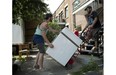 Left to right, movers Charles Lalonde and Alexis Gaudet move a dryer down a second floor apartment on de Bordeaux street in Montreal, Tuesday July 1, 2014.