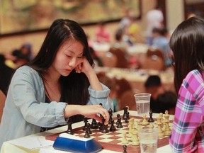 Indy Ma makes a move during a game of chess at The Canadian youth chess championship at the Queen Elizabeth Hotel Thursday, July 17, 2014 in Montreal.