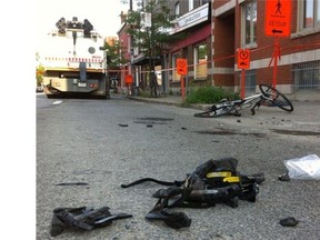 A cyclist's helmet lies in pieces in the foreground after he collided with a city street cleaner on Frontenac St just north of Ontario St. on Wednesday, July 30, 2014.